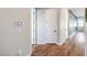 Hallway with wood floors and a smart home control panel on the wall and access to different rooms at 10250 Tree Blossom Ave, Las Vegas, NV 89166
