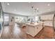 Open concept kitchen with large island, and view of the connected living room and backyard at 10250 Tree Blossom Ave, Las Vegas, NV 89166