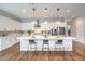 Bright kitchen with an island and seating, stainless appliances, and light countertops at 10250 Tree Blossom Ave, Las Vegas, NV 89166