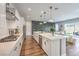 Bright kitchen with white cabinets, stainless appliances, and an island overlooking the living room at 10250 Tree Blossom Ave, Las Vegas, NV 89166