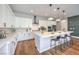 Bright kitchen with white cabinetry, quartz countertops, stainless steel appliances, and a large central island at 10250 Tree Blossom Ave, Las Vegas, NV 89166
