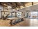Expansive lounge with soaring vaulted ceiling, stone fireplace, communal tables, and expansive windows at 10250 Tree Blossom Ave, Las Vegas, NV 89166