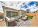 Relaxing patio with stylish furniture, paved flooring, and sliding glass doors for seamless indoor-outdoor living at 10250 Tree Blossom Ave, Las Vegas, NV 89166