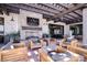 Relaxing patio features a stone fireplace, wooden beam pergola, and comfortable lounge seating at 10250 Tree Blossom Ave, Las Vegas, NV 89166