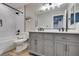 Well-lit bathroom with double vanity, soaking tub, marbled tile shower and modern fixtures at 1223 Starstone Ct, Henderson, NV 89014