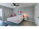 Stylized bedroom with full bed, textured wallpaper accent wall, and decorative curtains over windows at 1223 Starstone Ct, Henderson, NV 89014