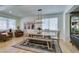 Dining area features a modern chandelier, farmhouse table, bench seating and wood floors at 1223 Starstone Ct, Henderson, NV 89014