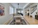 Open-concept dining area with light wood floors and natural light from large windows at 1223 Starstone Ct, Henderson, NV 89014