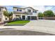 Two story home with a three car garage, artificial lawn and inviting entryway at 1223 Starstone Ct, Henderson, NV 89014