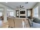Open-concept living area with fireplace and views to dining area and kitchen at 1223 Starstone Ct, Henderson, NV 89014