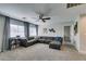 Expansive living room with comfortable gray sectional, neutral carpet and plenty of natural light at 1223 Starstone Ct, Henderson, NV 89014
