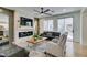 Comfortable living room features a fireplace, ceiling fan, and sliding glass door at 1223 Starstone Ct, Henderson, NV 89014