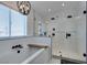 A bright bathroom includes a bathtub with fixtures and a glass-enclosed shower with dual shower heads at 1223 Starstone Ct, Henderson, NV 89014