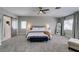 Spacious main bedroom with plush carpet, neutral color scheme, barn door to bath, and sunny windows at 1223 Starstone Ct, Henderson, NV 89014