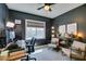 Home office with dark walls, natural light, and comfortable seating, perfect for productivity and focus at 1223 Starstone Ct, Henderson, NV 89014