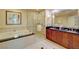 Luxurious bathroom featuring a soaking tub, glass-enclosed shower, and dual-sink vanity with ample counter space at 135 E Harmon Ave # 804, Las Vegas, NV 89109