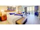 Comfortable bedroom featuring a plush king bed, cozy sitting area, and a large window with scenic city vistas at 135 E Harmon Ave # 804, Las Vegas, NV 89109