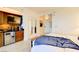 Comfortable bedroom with convenient kitchenette featuring a mini fridge, microwave, and sleek countertops for modern living at 135 E Harmon Ave # 804, Las Vegas, NV 89109