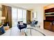 Cozy living room with a comfortable armchair, a modern coffee table, and floor-to-ceiling windows offering scenic views at 135 E Harmon Ave # 804, Las Vegas, NV 89109