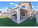 Backyard features a covered patio, artificial grass, and a basketball hoop at 1618 Meno Peak St, Las Vegas, NV 89115