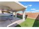 A spacious covered patio and artificial grass highlight this backyard at 1618 Meno Peak St, Las Vegas, NV 89115