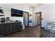 Bedroom featuring hardwood floors, modern fan, window, walk-in closet, and an ensuite at 1618 Meno Peak St, Las Vegas, NV 89115