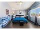 Bedroom featuring hardwood floors, modern fan, window, walk-in closet, and an ensuite at 1618 Meno Peak St, Las Vegas, NV 89115