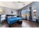 Bedroom featuring hardwood floors, modern fan, window, walk-in closet and an ensuite at 1618 Meno Peak St, Las Vegas, NV 89115