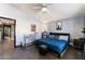 Bedroom featuring hardwood floors, modern fan, window, walk-in closet, and an ensuite at 1618 Meno Peak St, Las Vegas, NV 89115