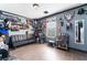 The bedroom is decorated with movie and sport memorabilia with a sleek black futon at 1618 Meno Peak St, Las Vegas, NV 89115