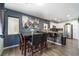 Open-concept dining area featuring a modern table, adjacent to the kitchen, with bright, natural light at 1618 Meno Peak St, Las Vegas, NV 89115