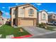 Charming two-story home with a well-manicured lawn, two-car garage, and landscaped yard at 1618 Meno Peak St, Las Vegas, NV 89115