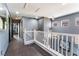 Hallway featuring wood floors, white railing, accent wall and recessed lights at 1618 Meno Peak St, Las Vegas, NV 89115