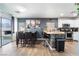 Bright kitchen and dining area with stainless steel appliances, bar seating, and modern fixtures at 1618 Meno Peak St, Las Vegas, NV 89115