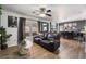 Comfortable living room with modern furnishings, a large window, stylish decor, and wood-look flooring at 1618 Meno Peak St, Las Vegas, NV 89115