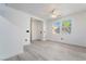 Bright living room featuring light gray floors, white walls, a ceiling fan and two windows at 1618 Meno Peak St, Las Vegas, NV 89115