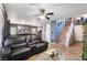 Inviting living area featuring a comfortable sofa, modern decor, and seamless flow to the dining area at 1618 Meno Peak St, Las Vegas, NV 89115