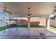 This covered patio offers a swing and lighting for outdoor living at 1618 Meno Peak St, Las Vegas, NV 89115