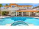 Expansive backyard with pool and hot tub of a beautiful two story home with many windows at 1840 Myrtle Island Dr, Las Vegas, NV 89117