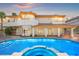 Stunning backyard showcasing a sparkling pool and spa with a view of the home's architecture at 1840 Myrtle Island Dr, Las Vegas, NV 89117