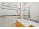 Bathroom with combined shower and bathtub with tiled walls and a wood vanity at 1840 Myrtle Island Dr, Las Vegas, NV 89117
