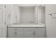Well-lit bathroom featuring a white vanity with marble countertop, large mirror and classic fixtures at 1840 Myrtle Island Dr, Las Vegas, NV 89117