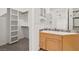 Bathroom vanity with marble countertop, updated fixtures, built-in storage, and an adjacent walk-in closet at 1840 Myrtle Island Dr, Las Vegas, NV 89117