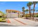 Long driveway leading up to this elegant two-story home featuring a tile roof and palm trees at 1840 Myrtle Island Dr, Las Vegas, NV 89117