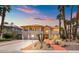 Elegant two-story home featuring a tile roof, palm trees, and an inviting walkway at 1840 Myrtle Island Dr, Las Vegas, NV 89117