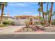 Elegant two-story home featuring a tile roof, palm trees, and an inviting walkway at 1840 Myrtle Island Dr, Las Vegas, NV 89117