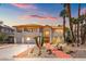 Elegant two-story home featuring a tile roof, palm trees, and an inviting walkway at 1840 Myrtle Island Dr, Las Vegas, NV 89117