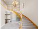 Grand foyer with a curved staircase, chandelier, and high ceilings offers a luxurious welcome at 1840 Myrtle Island Dr, Las Vegas, NV 89117