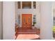 Inviting entryway with double doors, elegant columns, and lush landscaping details at 1840 Myrtle Island Dr, Las Vegas, NV 89117