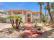 Charming two-story home with manicured desert landscaping and an inviting terracotta walkway at 1840 Myrtle Island Dr, Las Vegas, NV 89117